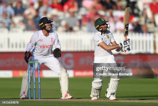 Keshev Maharaj of South Africa plays a shot as England wicket keeper Ben Foakes looks on during day two of the First LV= Insurance Test Match between...