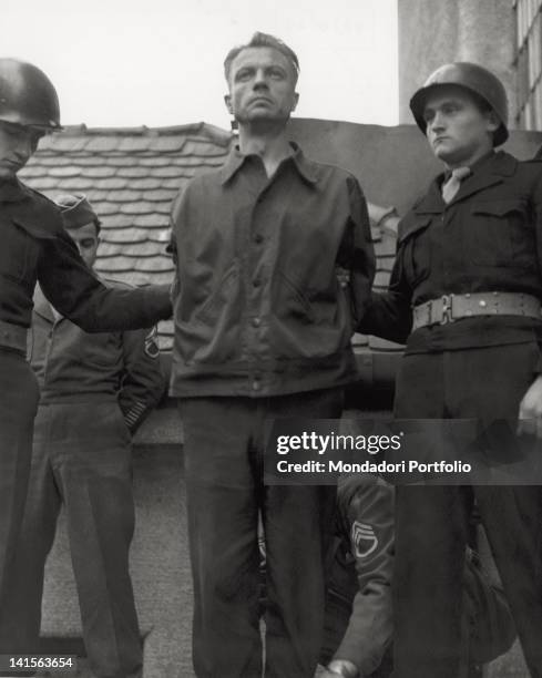 German Nazi war criminal Hermann Zisch is held by two American servicemen before his execution by hanging, at Landsberg Prison, Landsberg am Lech,...