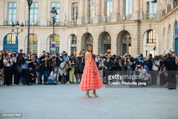 Model Cindy Bruna attends the Giambattista Valli show at Pavillon Vendome and poses for a large group of photographers in a pink salmon Giambattista...