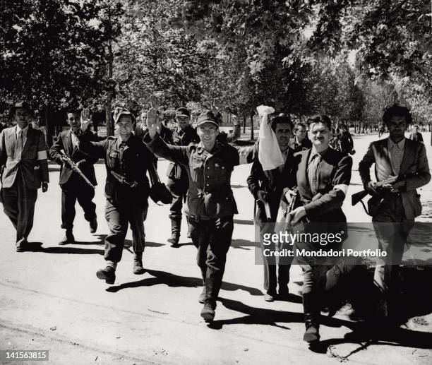 Group of soldiers from the German rear, their arms raised in sign of surrender, is escorted by a partisan unit. Modena, 22nd April 1945.