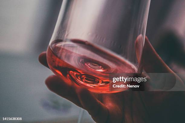 woman with glass of rosé in hand - alcohol and women stock-fotos und bilder