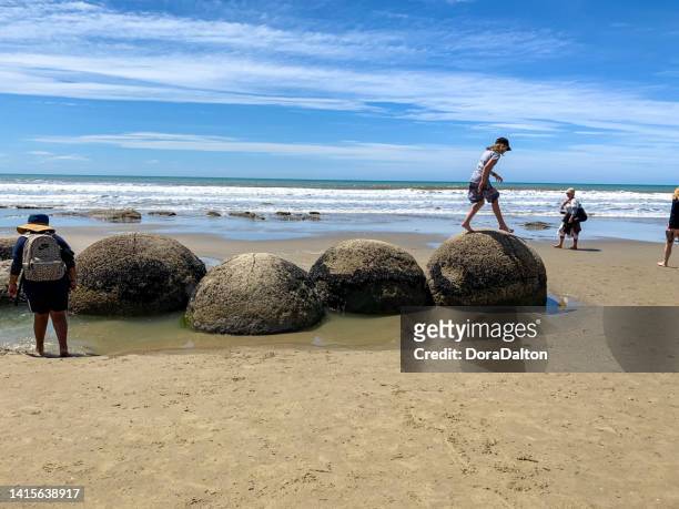 moeraki boulders at low tide, koekohe beach, otago, south island, new zealand - moeraki boulders stockfoto's en -beelden