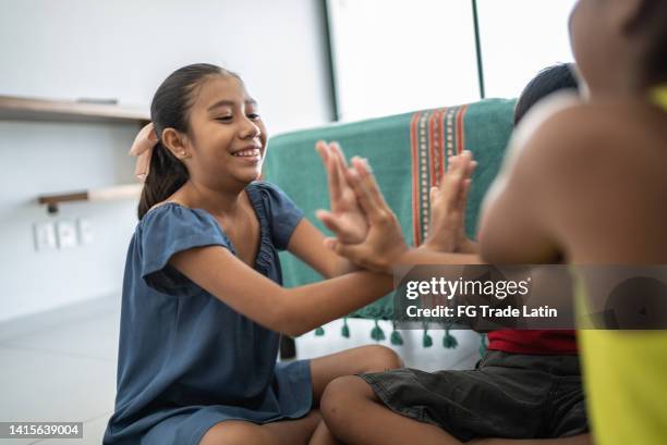 siblings playing hand game at home - clapping game stock pictures, royalty-free photos & images