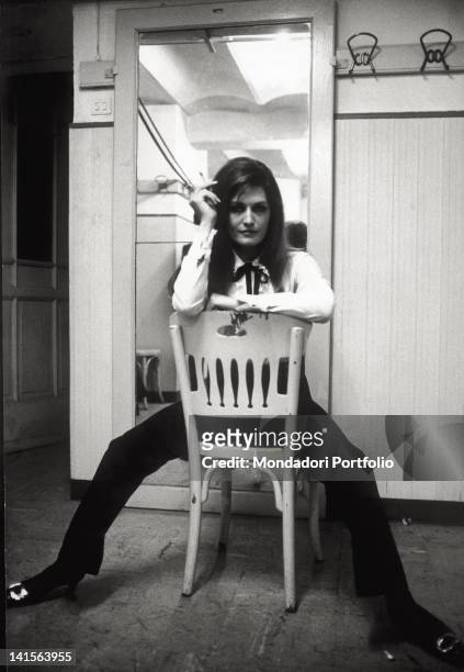 The Italian singer, naturalised French, Dalida poses on a chair at the XVII edition of Sanremo Italian Music Festival, where she sings the song 'Ciao...