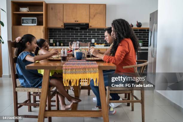 mexican family having lunch together in the dining room at home - mexican food on table stock pictures, royalty-free photos & images