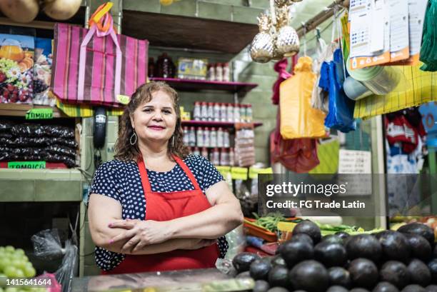 portrait of mature woman business owner at her market store - mexican mature women stock pictures, royalty-free photos & images