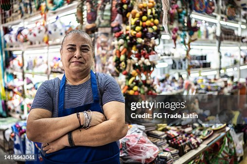 Portrait of mature woman small business owner in front of her shop Portrait of mature woman small business owner in front of her shop