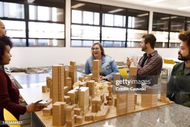 group of students talking around a city model - architectural model stockfoto's en -beelden