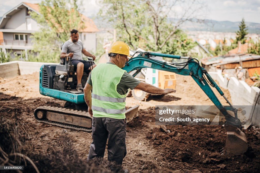 Engineer coordinating work on construction site