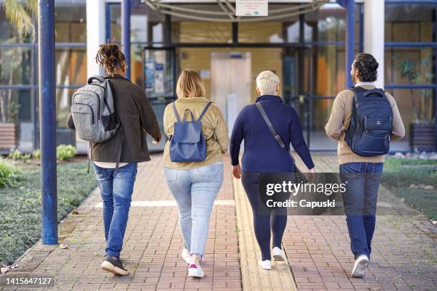 group of friends chatting while arriving on campus - dreadlocks back stock pictures, royalty-free photos & images