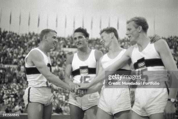 The four German athletes Bernd Cullmann, Armin Hary, Walter Mahlendorf and Martin Lauer rejoicing. They won the Olympic gold medal in 4x100 m relay....