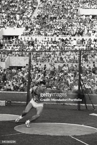 The American athlete Al Oerter partecipating at the throw of the discus competition. With a length of 58.43 m he conquers the world record and the...