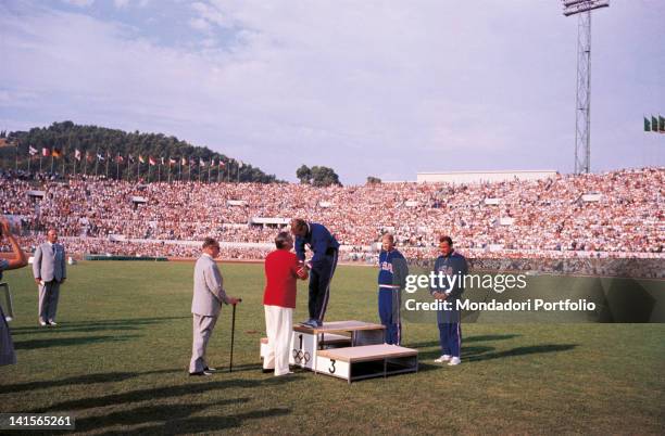 Prize-giving ceremony of male 400 mt obstacles at the Olympic Stadium of Rome. On the podium the winner Davis Glenn ; behind the podium, the second...