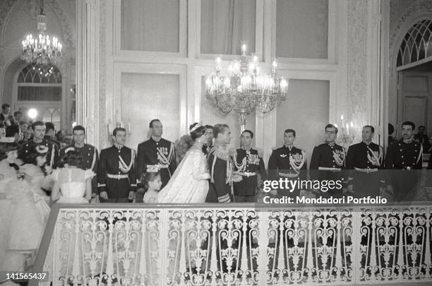 Shah of Persia Mohammad Reza Pahlavi and his Queen consort, Farah Pahlavi, walk together with court dignitaries and handmaids, to begin the...