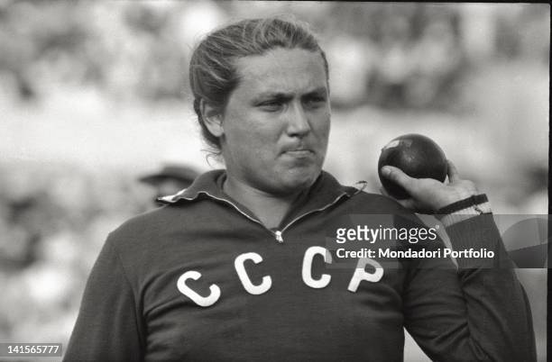 The Soviet shot-putter Tamara Press weigh up thoughful the metal sphere on her left arm, during the early phases of the olympic final; the Ukranian...