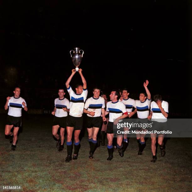 The players of Inter team are making a tour around the soccer field to celebrate the victory for the UEFA Champions League Cup. From left, Luis...