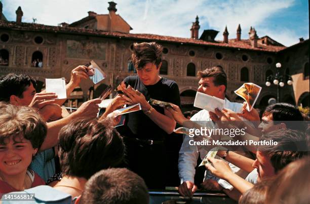 The Italian singer Bobby Solo is signing his autographs for his fans, after having taken part in the 5th edition of the music festival Cantagiro with...