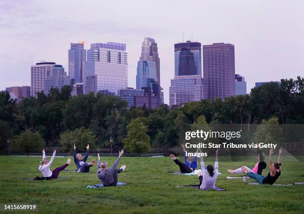 Yoga teacher Koreen Valdovinos of Open Minds Fusion Studio led a group during a Sunrise Yoga Circle Wednesday, Aug. 17, 2022 at Boom Island Park in...