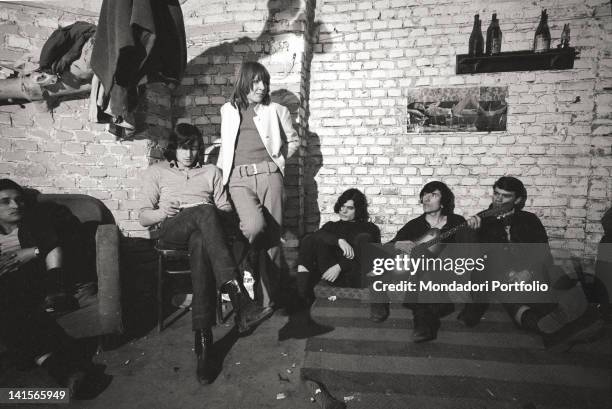 Italian beatniks having a rest at Mondo Beat club in Milan. Milan, 1960s