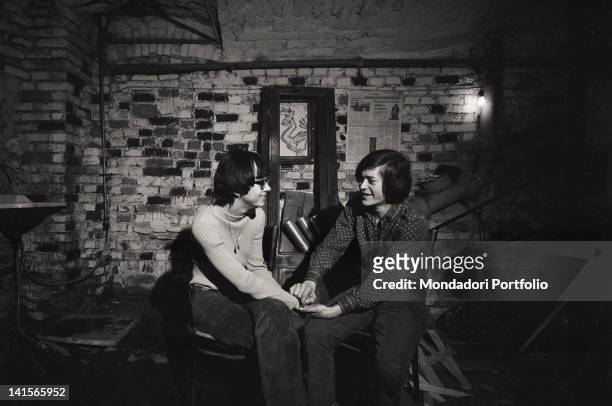Couple of Italian beatniks holding hands at Mondo Beat club in Milan. Milan, 1960s