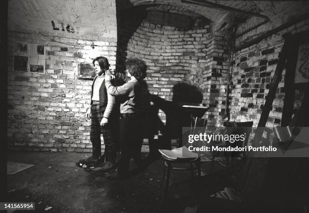 Italian beatnik combing a friend at Mondo Beat club in Milan. Milan, 1960s