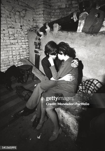 Italian beatniks hugging at Mondo Beat club in Milan. Milan, 1960s