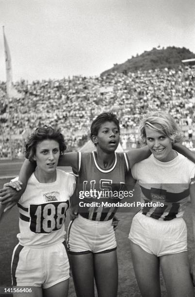 The American sprinter Wilma Rudolph posing with two female athletes during the Rome Olympics. Rome, 1960