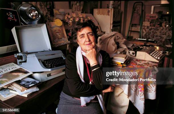 Portrait of Italian writer Alda Merini at her desk. 1980s