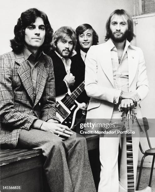 The Bee Gees musical group posing with a bass and a guitar. The band is composed by the three English brothers and musicians Barry, Robin and Maurice...