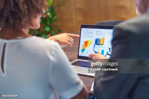 financial advisor or business people meeting discussing financial figures. - women talking in a bank with computer stock pictures, royalty-free photos & images