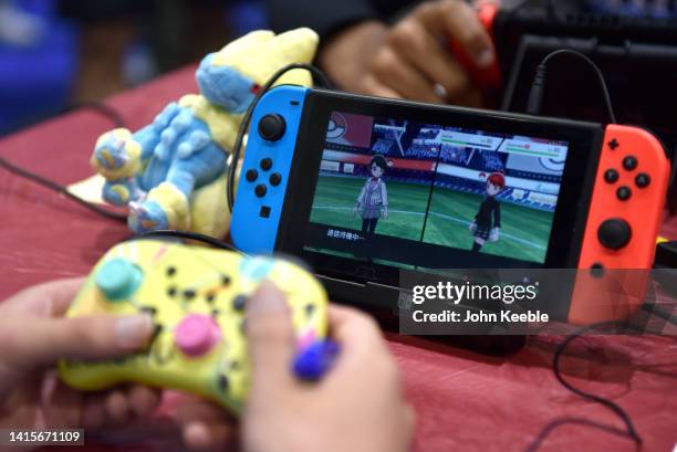 Competitor plays Pokemon on a Nintendo Switch console during the 2022 Pokémon World Championships at ExCel on August 18, 2022 in London, England. For...