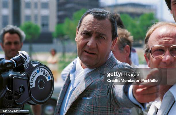 Actor Alberto Sordi during filming of 'Catherine and I'. He is pointing his finger at something offstage. 1980.