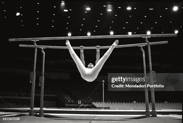 The Italian gymnast Franco Menichelli training on the parallel bars during Mexico City Olympics. Mexico City, October 1968