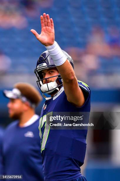 Jacob Eason of the Seattle Seahawks waves to the crowd prior to the preseason game against the Chicago Bears at Lumen Field on August 18, 2022 in...