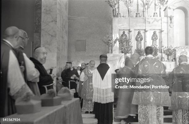 Padre Pio celebrating the mass with other priests in the church of Santa Maria delle Grazie. San Giovanni Rotondo, 1960s