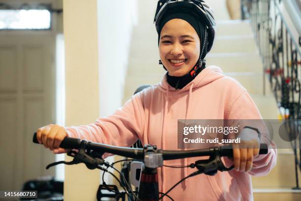 young muslim woman steps the stair holding her bike go to sport - portrait of young woman standing against steps imagens e fotografias de stock