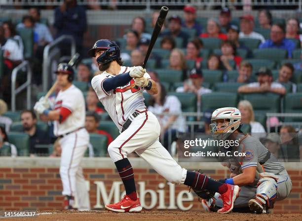 Dansby Swanson of the Atlanta Braves hits a RBI double in the third inning to score Robbie Grossman against the New York Mets at Truist Park on...