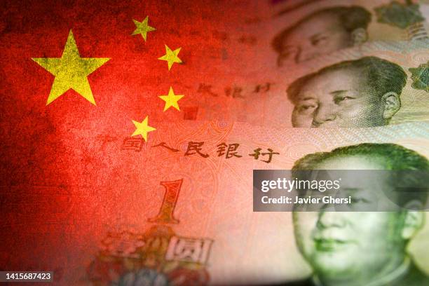 chinese yuan cash bills and chinese flag - deflación economía fotografías e imágenes de stock