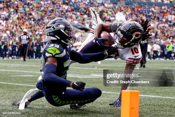 Tariq Woolen of the Seattle Seahawks tackles Nsimba Webster of the Chicago Bears on the 3-yard-line in the second quarter during the preseason game...