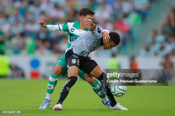 Omar Campos of Santos fights for the ball with Byron Castillo of Leon during the 9th round match between Santos Laguna and Leon as part of the Torneo...