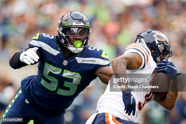 Boye Mafe of the Seattle Seahawks looks to tackle Trestan Ebner of the Chicago Bears in the second quarter during the preseason game at Lumen Field...