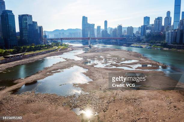 The Jialing River bed at the confluence with the Yangtze River is exposed due to drought on August 18, 2022 in Chongqing, China. The water level of...