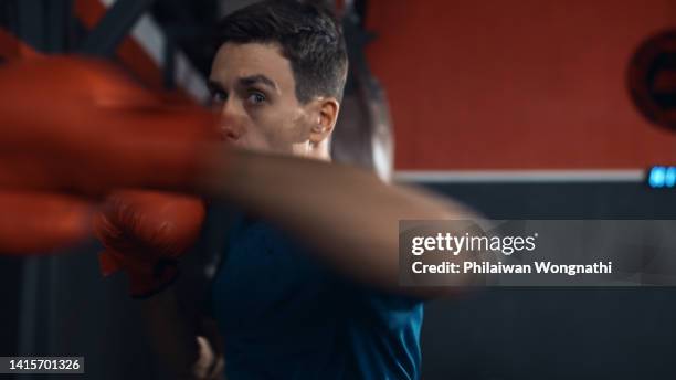 young man fixing boxing in the gym exercise, camera view. - sweat face stock pictures, royalty-free photos & images