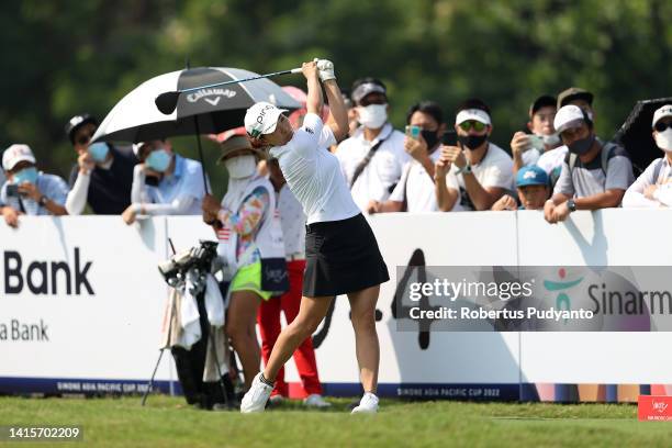 Hinako Shibuno of Japan hits her tee shot on the 18th hole during day two of the Simone Asia Pacific Cup at Pondok Indah Golf Course on August 19,...