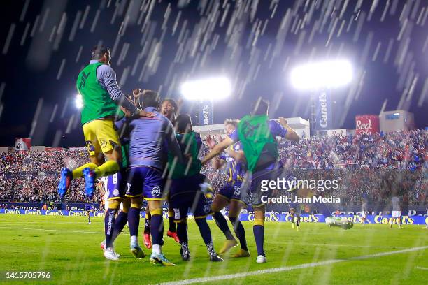 Abel Hernandez of San Luis celebrates with teammates after scoring his team's third goal during the 9th round match between Atletico San Luis and...