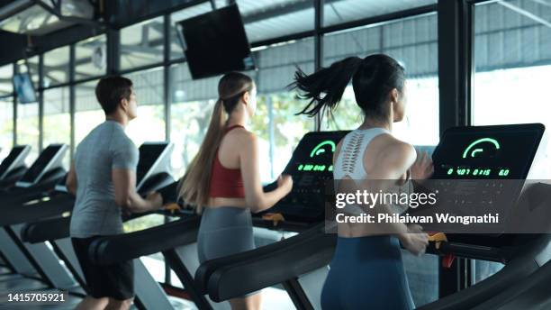 diverse people running on treadmill - gymnastique photos et images de collection