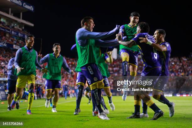 Abel Hernandez of San Luis celebrates with teammates after scoring his team's third goal during the 9th round match between Atletico San Luis and...