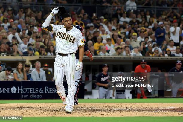 Juan Soto of the San Diego Padres reacts after striking out with bases loaded as Keibert Ruiz of the Washington Nationals looks on during the seventh...