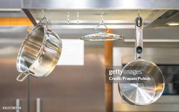 stainless steel kitchenware hang on steel bar - stew pot stock pictures, royalty-free photos & images