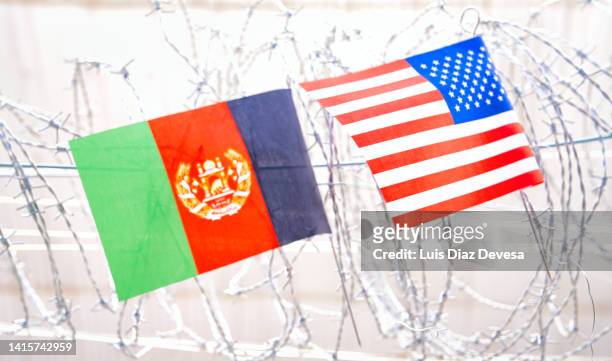 afganistán flag and usa - american flag on barbed wire. - afganistán stock-fotos und bilder